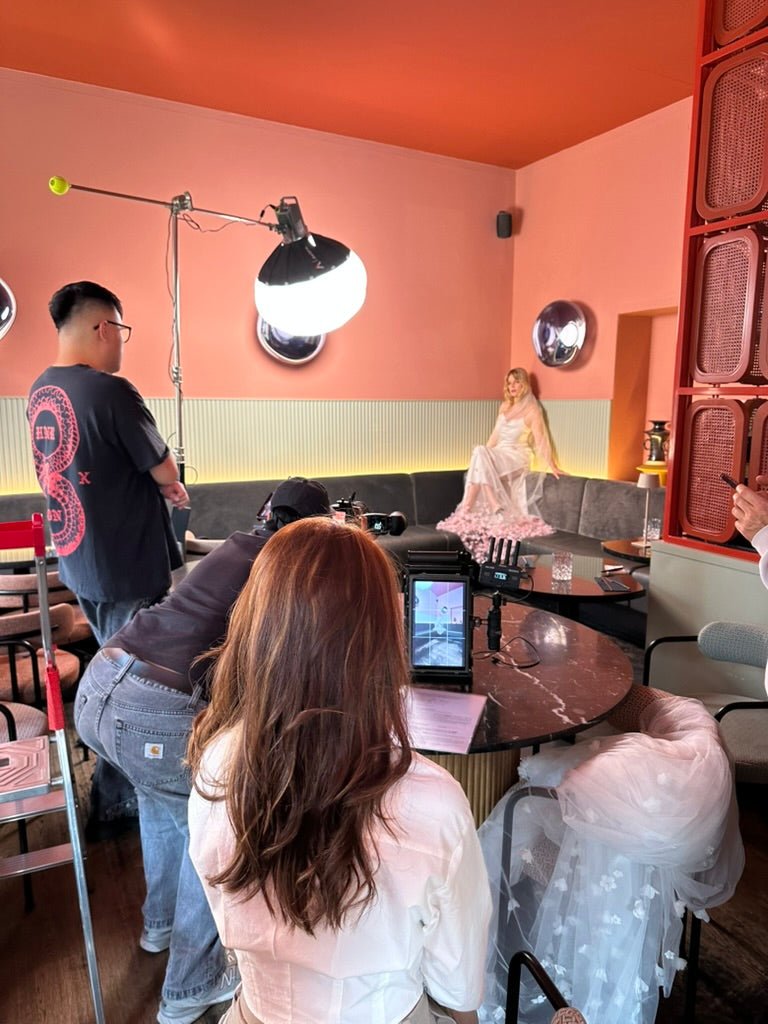 Braut mit Statement Brautschleier lang mit rosa Blumen Modell PUWAI beim Shooting fuer MOANA | Brautaccessoires Online Shop